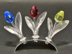 Swarovski crystal ornaments including a mouse, a vase of roses, a row of three tulips, a petal head,