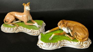 Pair of 19th century continental porcelain hounds on shaped bases with gilded borders