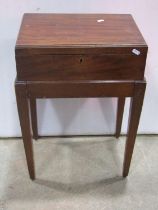 An Edwardian mahogany oval drop leaf occasional table with bow fronted frieze drawer raised on