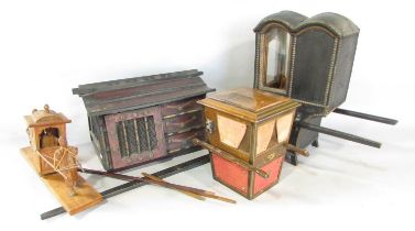 A black lacquered brass studded model of a sedan chair 25cm high, a wooded model of a sedan chair