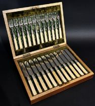 A canteen of fish knives and forks for twelve settings and a bone handled sprung asparagus server.