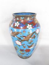 An antique Cloisonné Vase decorated with birds amongst flowers on a blue ground, 28.5 cm high.