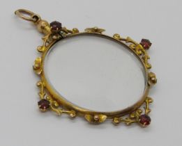 Early 20th century 9ct picture pendant set with four garnets, 6.4g (af)