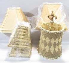A pair of graded square gold fabric lampshades together with a rectangular silk shade similar in