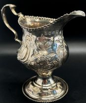 A George III milk jug with floral engraved decoration London 1776, maker Thomas Streetin, 9cm high
