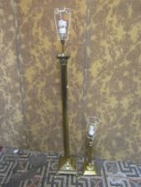 A polished brass effect standard lamp in the form of a Corinthian column with stepped base and