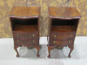 A pair of reproduction Georgian style bedside/lamp tables, the serpentine front partially enclosed