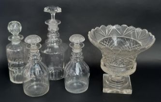 Four 19th century glass decanters and cut glass rose bowl, raised on a square base 26cm diam x