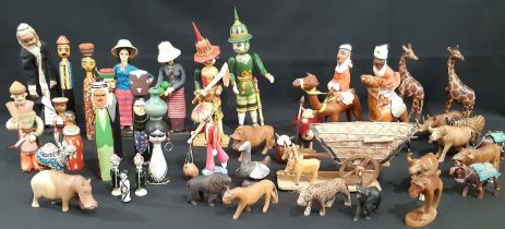 A collection of vintage wooden dolls and carved animals, from Myanmar, Thailand, Europe and and