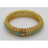 Vintage foreign yellow metal bracelet set with a line of turquoise cabochons (one vacant), with twin