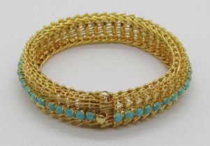 Vintage foreign yellow metal bracelet set with a line of turquoise cabochons (one vacant), with twin