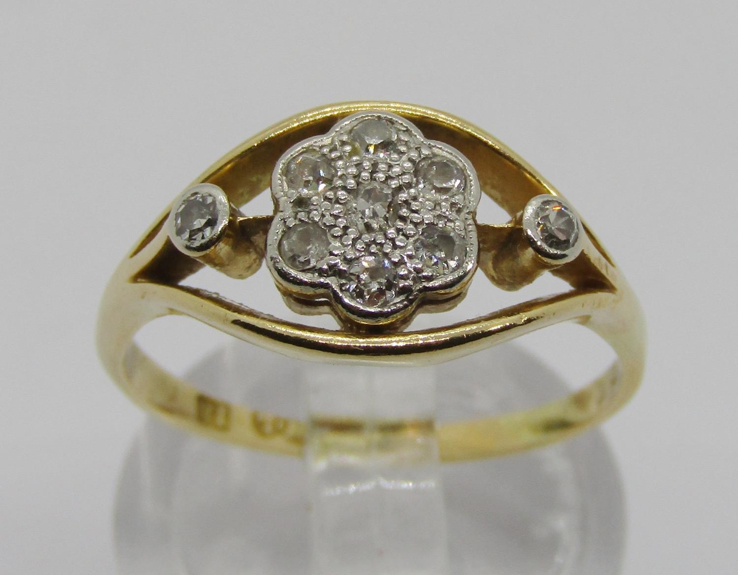 Early 20th century 18ct diamond daisy cluster ring, maker 'W.L', size O/P, 3.1g