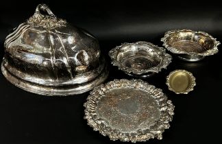 A silver plated domed meat cover, a pair wine bottle coaster, a silver plated tray and a small dish.