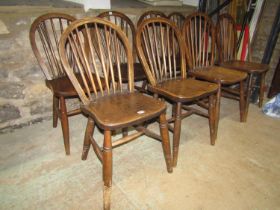 A set of eight Windsor elm and beechwood hoop and stick back dining chairs with saddle shaped