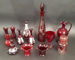 A mixed selection of Cranberry and Bohemian red glassware including decanters, vases, a jug, and a