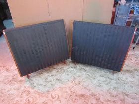 A pair of vintage Quad floor standing electrostatic speakers of curved form raised on square tapered