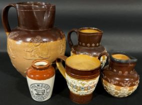 Three Doulton salt glazed ewers of varying sizes, a further Doulton Lambeth mug with loop handle and