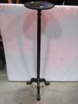 A Georgians tyle mahogany torchere with circular tray top raised on a simple turned column and