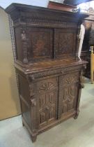 A Victorian gothic oak two sectional side cupboard in the old English style, the front elevation