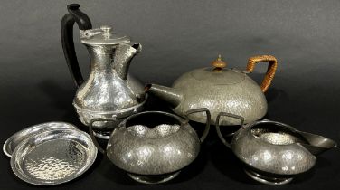 A three piece Tudric Pewter tea service, teapot, sugar bowl and milk jug, all with a lightly