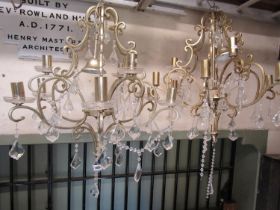 A pair of contemporary coated light metal open scrollwork eight branch hanging ceiling lights with