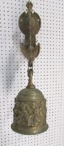 A 19th century brass porch bell, decorated with cherubs and scrolling, hung from a wall mounted