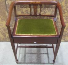 An inlaid Edwardian mahogany piano stool with hinged upholstered box seat beneath a shaped and