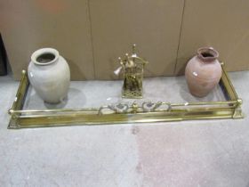 A brass fender small companion set and two earthenware jugs