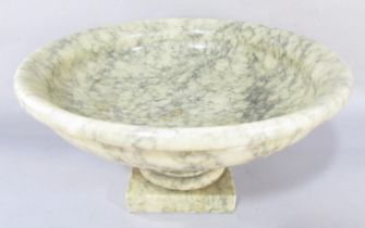 A mottled green alabaster tazza, 30cm diam, raised on a square base.