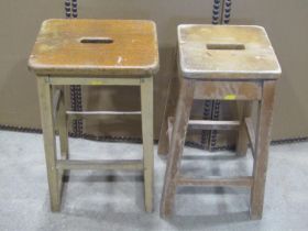 Two similar vintage stained beechwood ex lab/school stools with square cut supports and rails