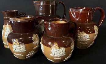 Collection of Doulton stoneware jugs with applied detail in varying sizes (12)