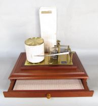A Casella Barograph, with bevelled glass case on a mahogany base with a single drawers, together