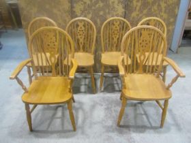 A set of six modern beech Windsor wheel back dining chairs (4&2)