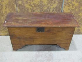 A simple antique elm countrymade boarded coffer with hinged lid, steel lock plate and bracket shaped