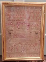19th Century needlework sampler by Margret Drysdale, with the alphabet and numbers above and a