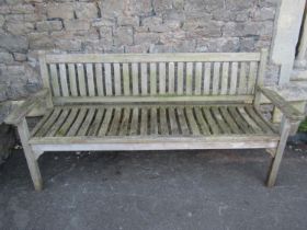 A good quality weathered contemporary teak garden bench with slatted seat and back (labelled verso