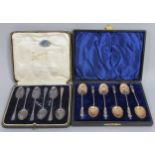 A cased sex of 6 silver teaspoons, a cased set of 6 apostle spoons, 7 napkin rings, sugar nips and a