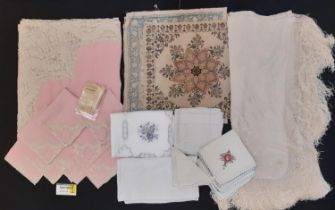 A collection of vintage textiles including an unusual 1930's table linen set of pink cloth and 8