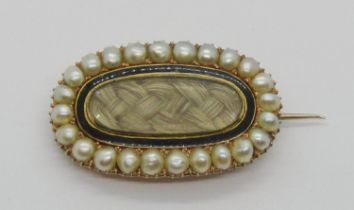 Early Victorian yellow metal mourning brooch, containing woven hair framed by black enamel within