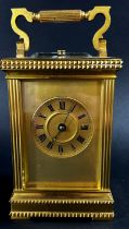 A 19th century brass French carriage clock, the case with reeded and decorative borders, with