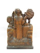 A 19th century oak carving of Saint Francis of Assisi taming a wolf before a flock of sheep,