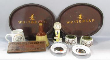 A pair of Whitbread metal trays, a pair Whitbread match strikers, Martel Brandy Mug etc