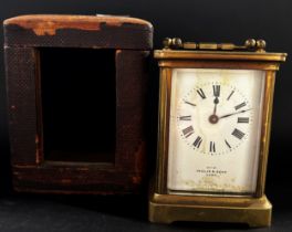 Brass carriage clock with bespoke travel case, the clock with eight day time piece