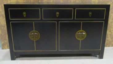 A contemporary Chinese lacquered sideboard enclosed by four doors beneath three drawers with petal