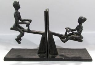 A pair of novelty wrought iron see-saw book ends.