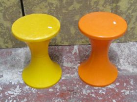 A pair of mid 20th century stools on waisted stems in orange and yellow plastic