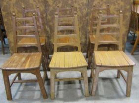 A set of six arts and crafts style oak chairs by Webbers of Croydon with tapered ladder backs over