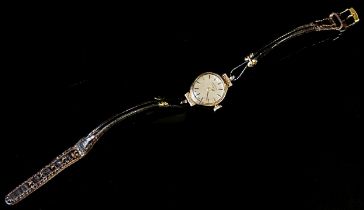 Rotary: A ladies 9ct yellow gold cased wristwatch, 15mm case, with textured lugs, leather strap.