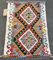 A Chobi kilim, mat with a multicoloured diamond pattern, 87 x 60cm, together with a Chobi kilim