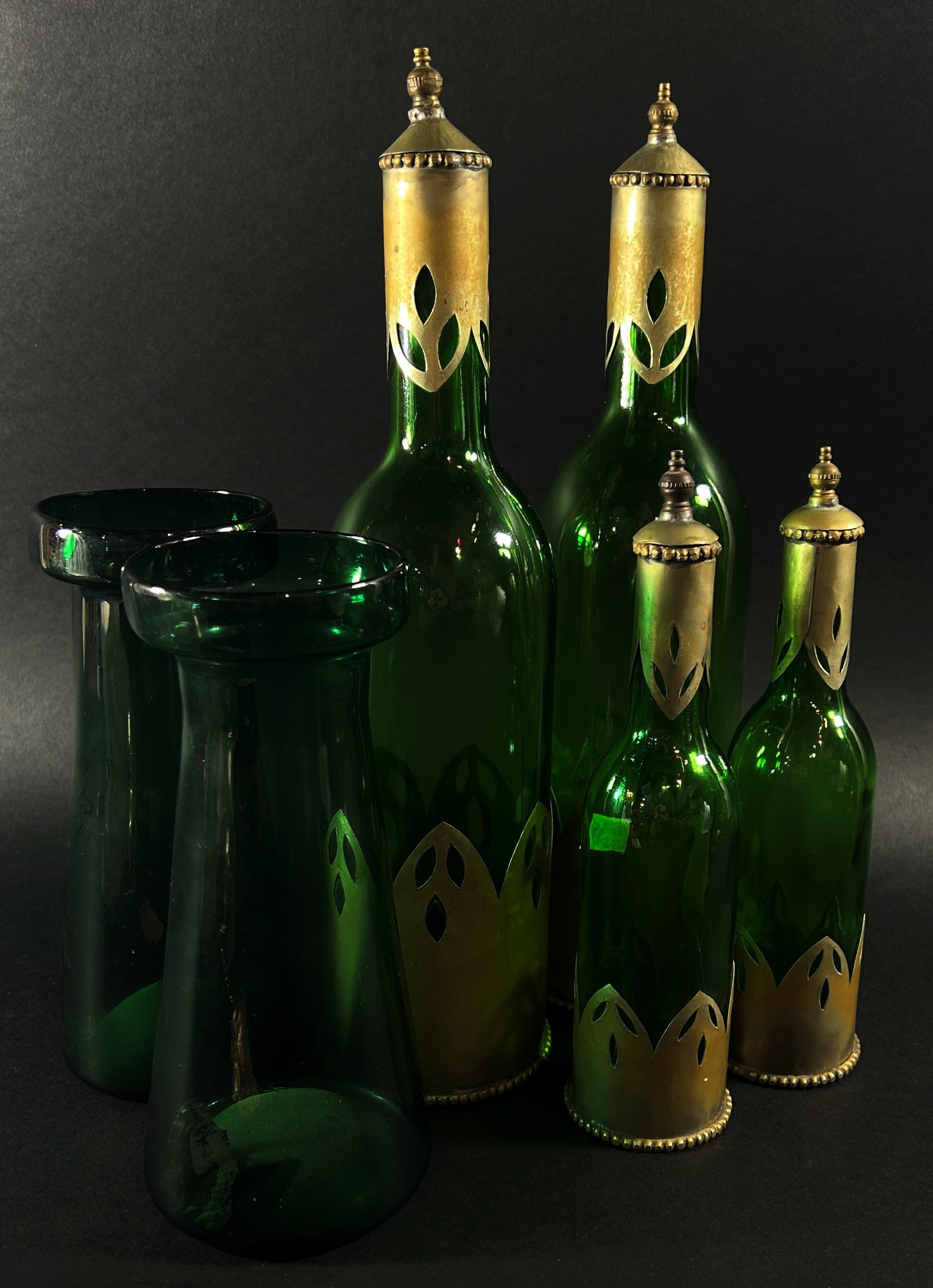 A mixed decorative collection to include four bottle green bottles with metal sleeves a pair of